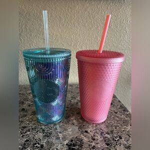 Two grande sized (16fl oz) Starbucks tumblers.